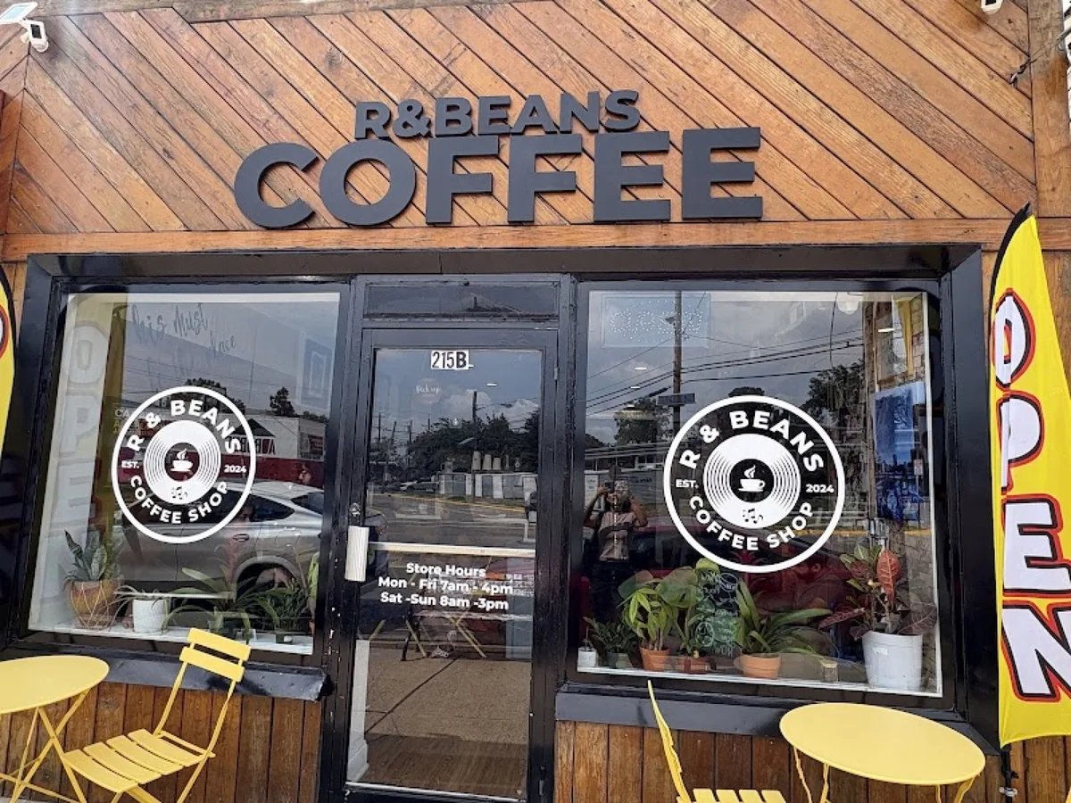 The R&Beans storefront with its wood sign and yellow chairs on the sidewalk